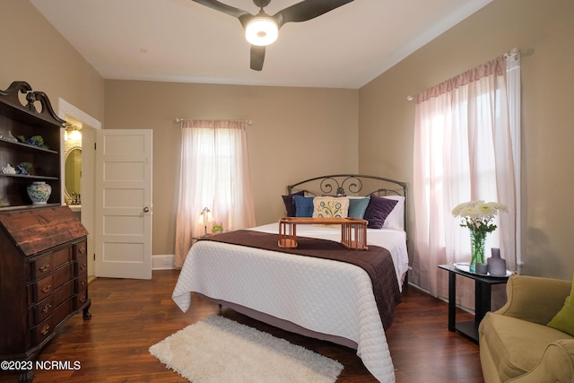 bedroom featuring a ceiling fan, arched walkways, multiple windows, and dark wood finished floors