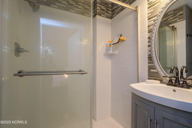 full bathroom with a shower stall and vanity