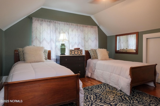 bedroom with lofted ceiling and wood finished floors