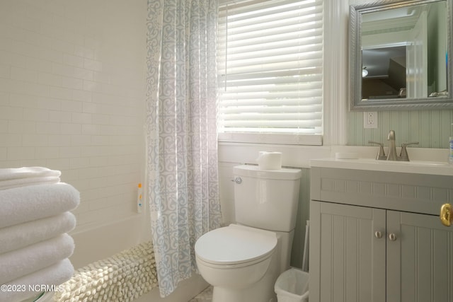 bathroom with shower / bath combo with shower curtain, vanity, and toilet