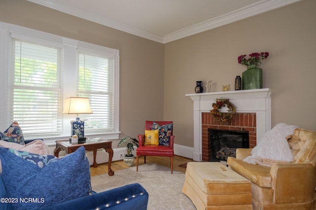 living area featuring a brick fireplace, crown molding, baseboards, and wood finished floors