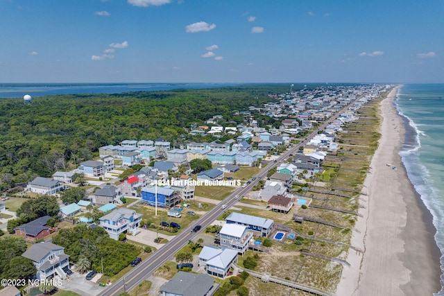 birds eye view of property with a view of the beach and a water view