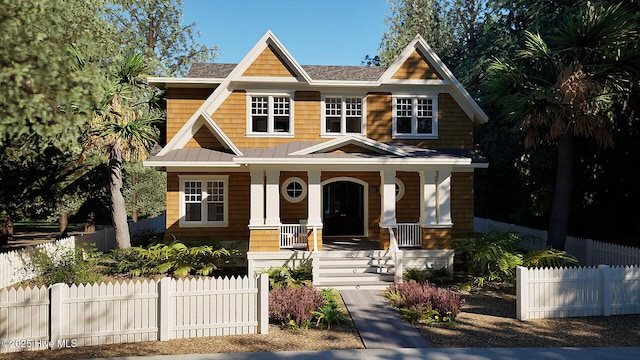 view of front of house featuring a standing seam roof, fence, covered porch, and metal roof