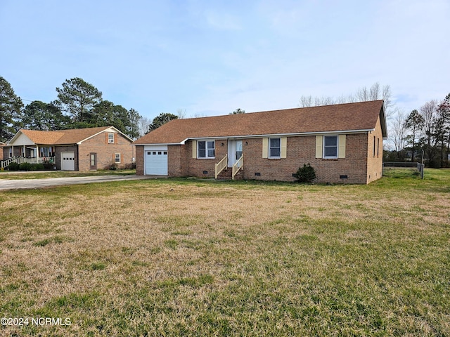 ranch-style home with a front lawn and a garage