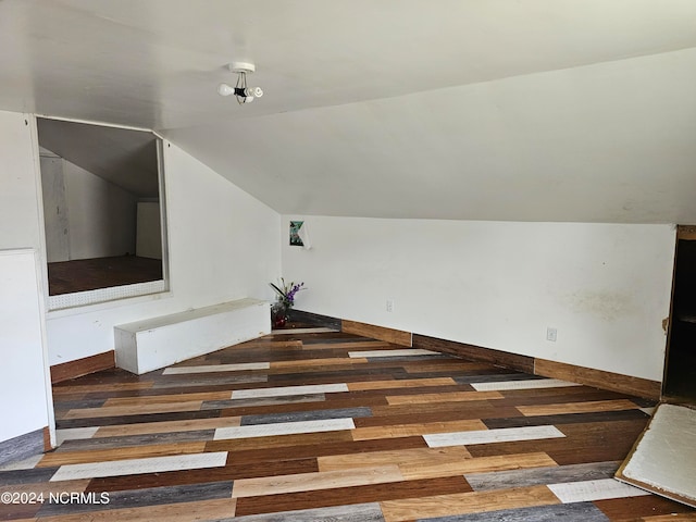 additional living space featuring dark hardwood / wood-style flooring and vaulted ceiling