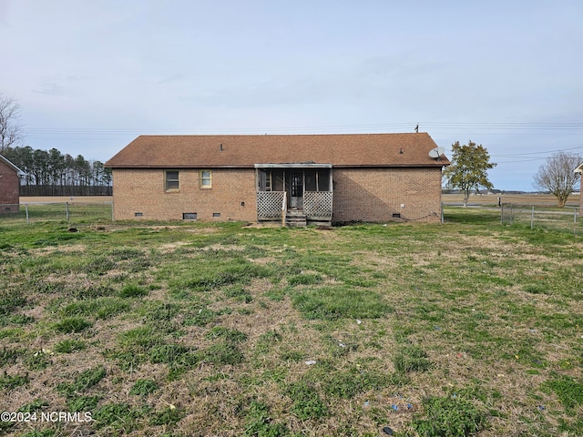 back of house with a yard