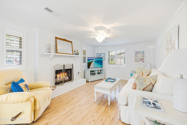 404 Mercer St, Oak Island, NC 28465 - living area with ornamental molding, wood finished floors, ceiling fan, and a brick fireplace