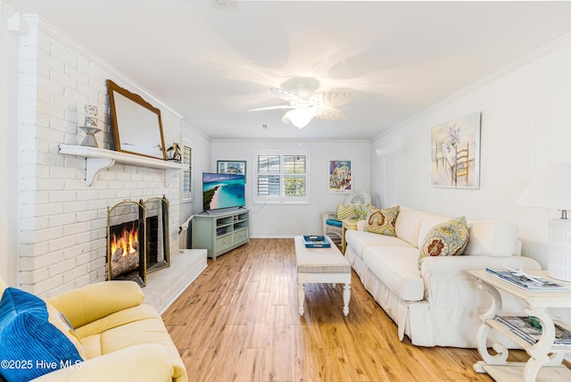 404 Mercer St, Oak Island, NC 28465 - living area featuring light wood-type flooring, a brick fireplace, ornamental molding, and ceiling fan