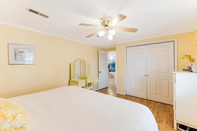 404 Mercer St, Oak Island, NC 28465 - bedroom with light wood-style floors, crown molding, a closet, and ceiling fan