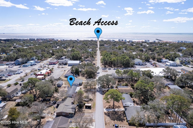 404 Mercer St, Oak Island, NC 28465 - aerial perspective of suburban area with a tree filled landscape and a large body of water