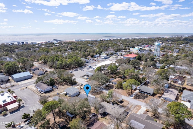 404 Mercer St, Oak Island, NC 28465 - aerial perspective of suburban area with a large body of water and a tree filled landscape