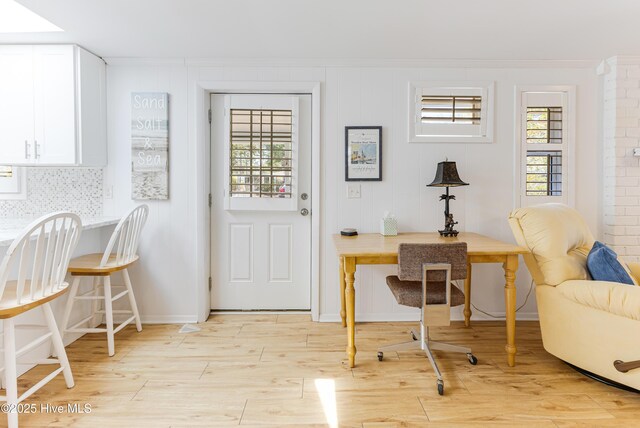 404 Mercer St, Oak Island, NC 28465 - entryway featuring ornamental molding, light wood-type flooring, and plenty of natural light
