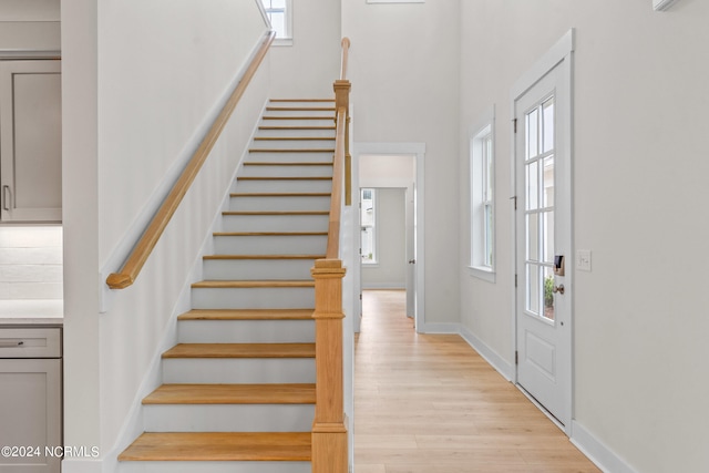 foyer entrance featuring a wealth of natural light and light hardwood / wood-style floors