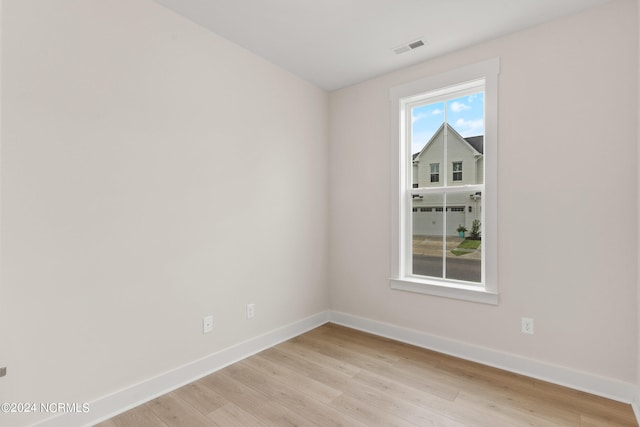 empty room with light hardwood / wood-style floors