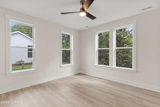 empty room with ceiling fan and light wood-type flooring