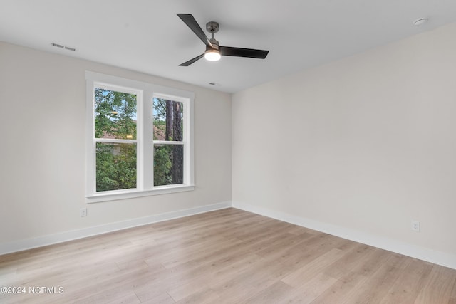 empty room featuring ceiling fan and light hardwood / wood-style flooring