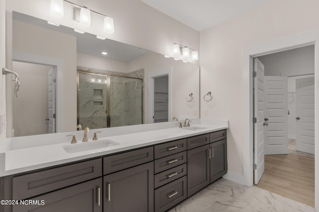 bathroom featuring walk in shower and vanity