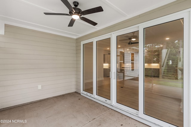 unfurnished sunroom featuring ceiling fan