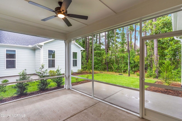 unfurnished sunroom featuring ceiling fan