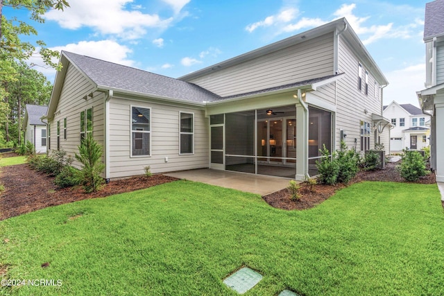 rear view of house with a yard, a sunroom, a patio, and ceiling fan