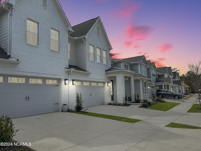 property exterior at dusk with a garage