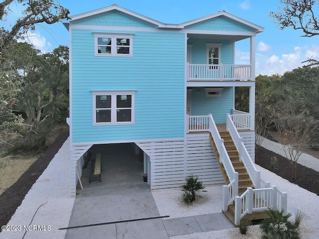 view of front of property featuring a balcony and a patio area