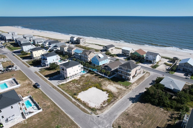 bird's eye view with a water view and a view of the beach