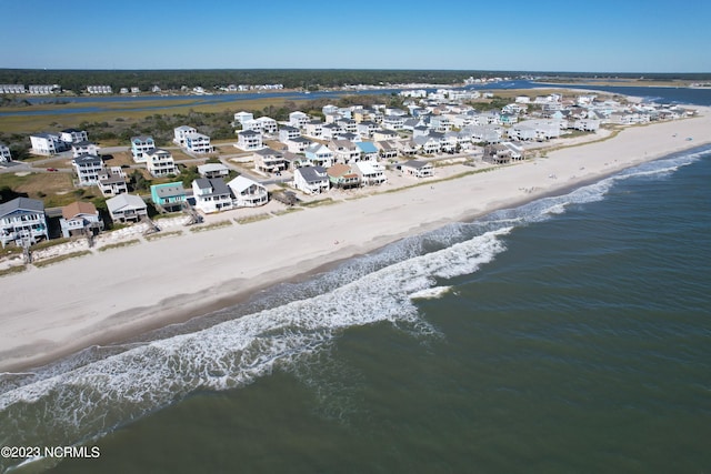 birds eye view of property featuring a water view and a view of the beach