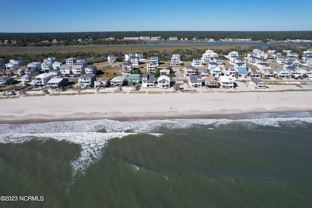 birds eye view of property with a beach view and a water view