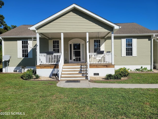 bungalow-style home with covered porch and a front lawn