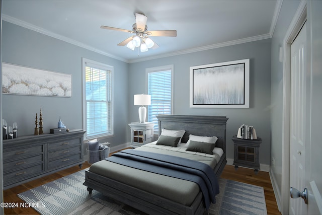 bedroom featuring dark hardwood / wood-style flooring, ceiling fan, a closet, and crown molding