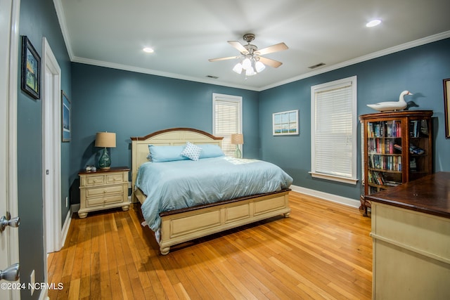 bedroom with light hardwood / wood-style floors, ceiling fan, and ornamental molding