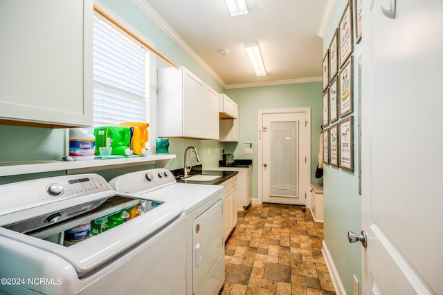 laundry area with washer and clothes dryer, crown molding, cabinets, and sink