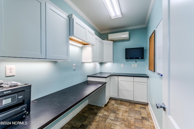 kitchen with white cabinets, crown molding, and a wall mounted AC