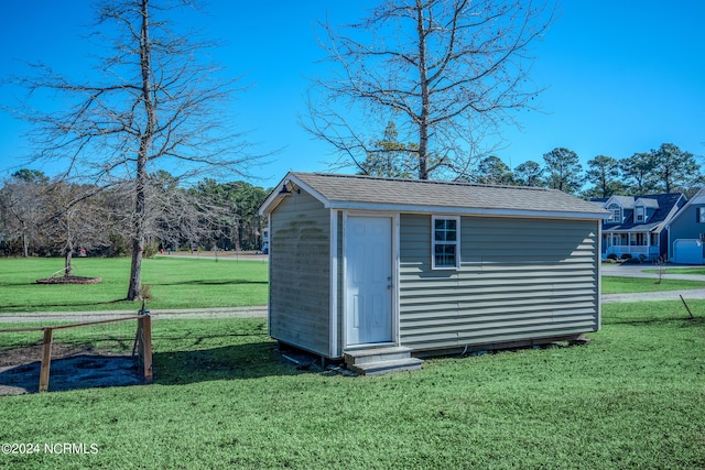 view of outdoor structure with a lawn