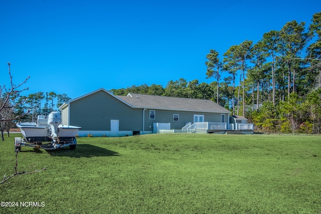 back of house featuring a lawn