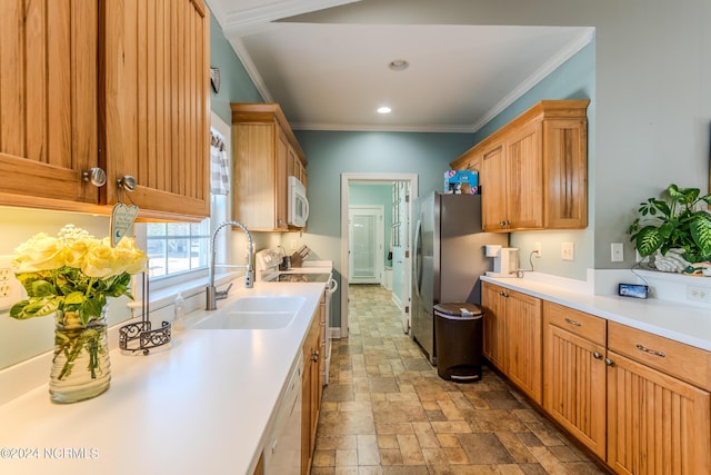 kitchen featuring white appliances, ornamental molding, and sink