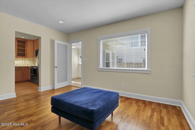 bedroom with light wood-type flooring and baseboards