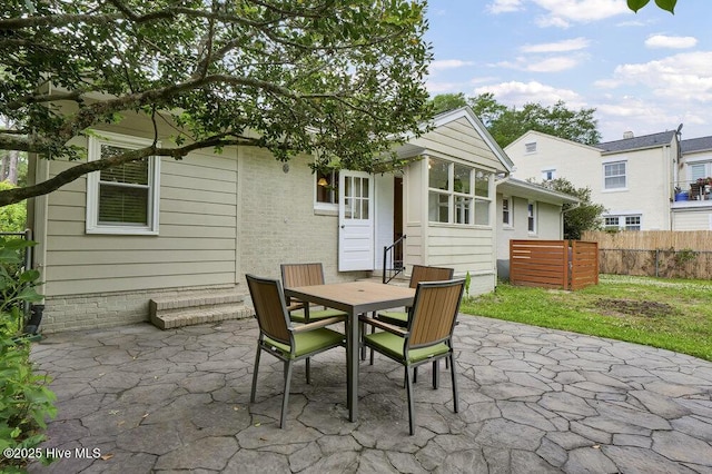 back of house with a patio area, fence, and outdoor dining area
