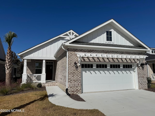 view of front of house with a garage and a porch