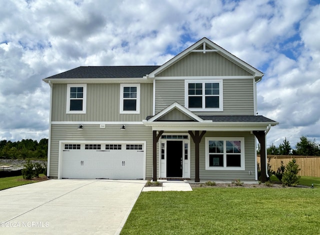 view of front of property with a garage, a shingled roof, concrete driveway, fence, and a front yard