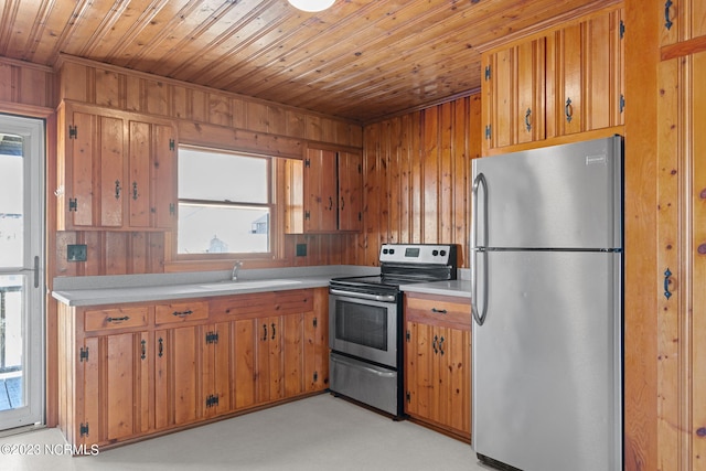 kitchen featuring a healthy amount of sunlight, appliances with stainless steel finishes, sink, light carpet, and wooden ceiling