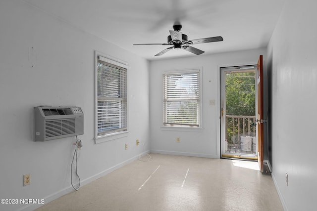 unfurnished room featuring a wall mounted AC and ceiling fan