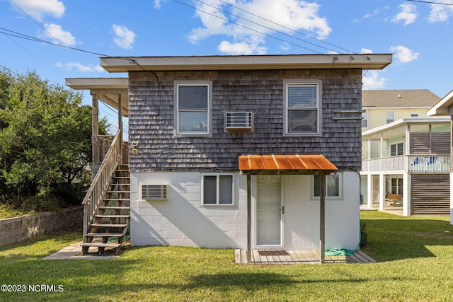 rear view of house featuring a yard