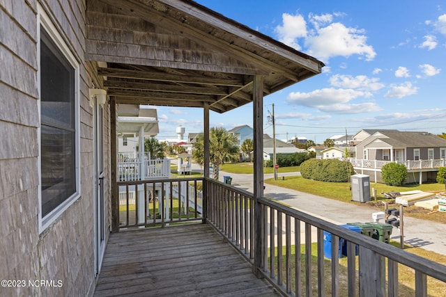 wooden terrace with a yard