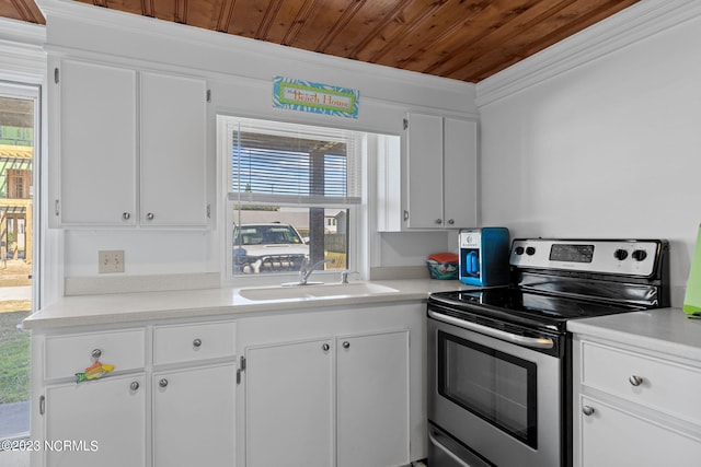 kitchen with sink, white cabinets, stainless steel range with electric cooktop, and a healthy amount of sunlight