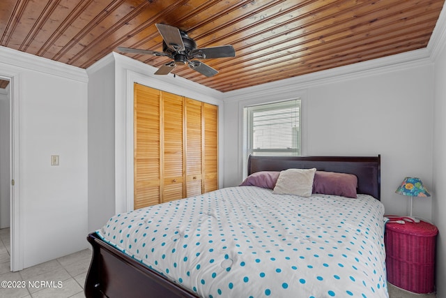 tiled bedroom featuring wooden ceiling, ceiling fan, crown molding, and a closet