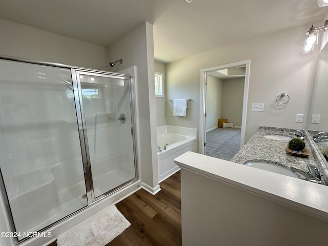 bathroom with separate shower and tub, hardwood / wood-style floors, and vanity