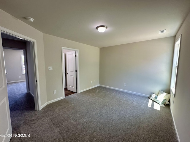 carpeted empty room with plenty of natural light