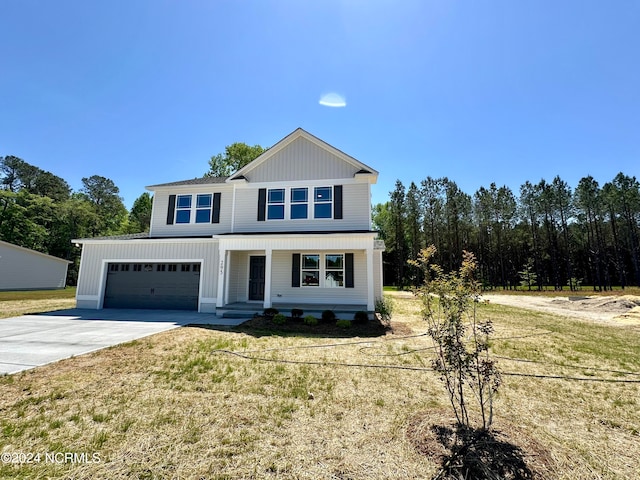 view of front of house with a front yard and a garage